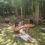 A Heal to Manifest ceremony - a group journaling outside