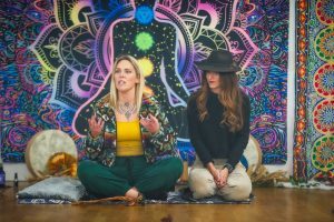 two women hosting sitting on the floor at a retreat day