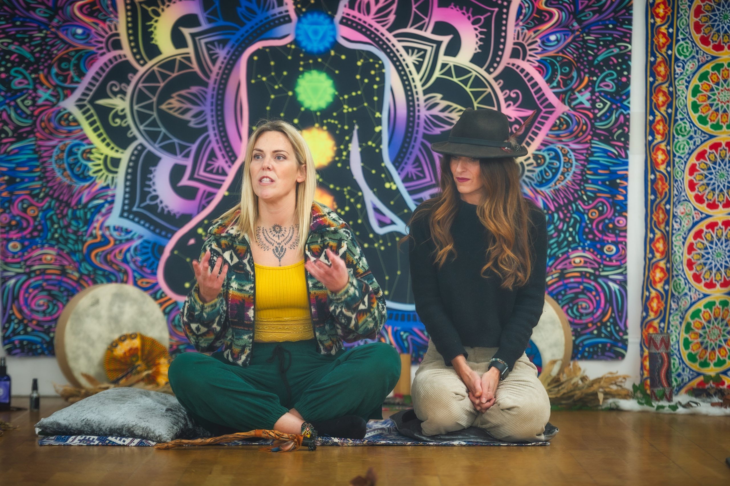 two women hosting sitting on the floor at a retreat day