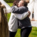 Ladies hugging at a Conscious Heart Warriors deep healing retreat