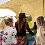 Connection between three ladies under marquee at a deep healing retreat with the Conscious Heart Warrior's
