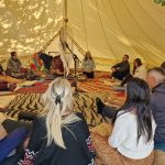 Group sound healing at the Conscious Heart Warrior's healing village for festivals.
