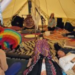 Group sound healing at the Conscious Heart Warrior's healing village for festivals.