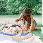 lady rattling over someone during a breathwork ceremony