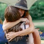 lady hugging girl at ceremony